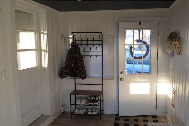 doorway with dark tile patterned flooring