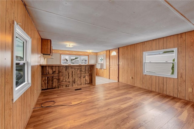 interior space featuring wood walls and light hardwood / wood-style floors