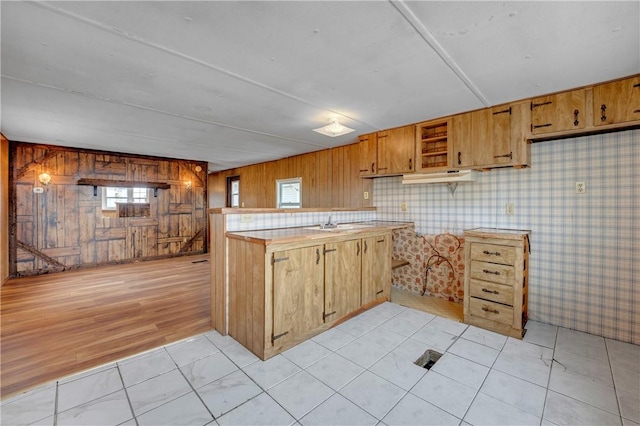 kitchen featuring kitchen peninsula and light tile patterned floors