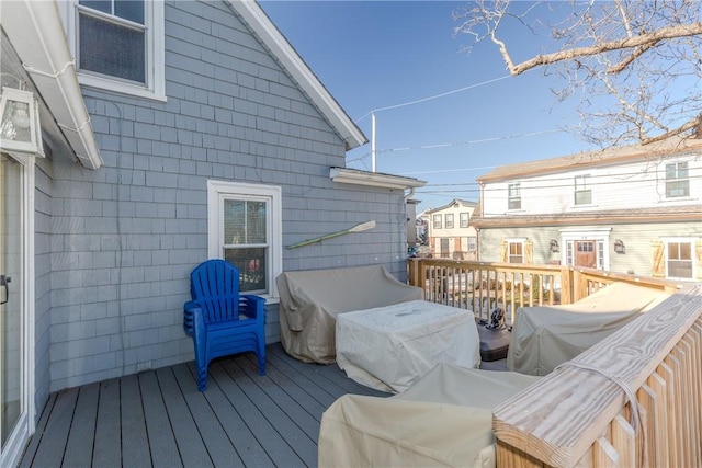 wooden deck featuring a grill