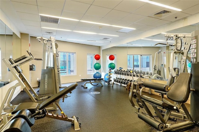 workout area with a drop ceiling and plenty of natural light