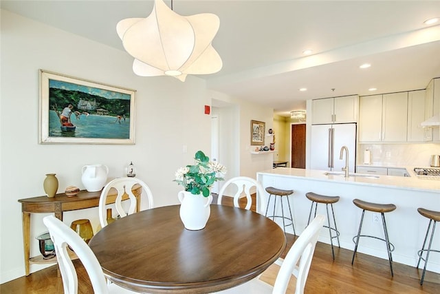 dining area featuring dark hardwood / wood-style flooring and sink