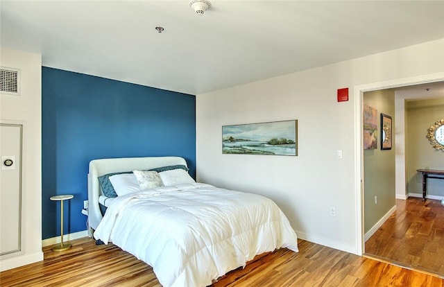 bedroom featuring hardwood / wood-style flooring