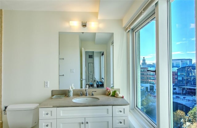 bathroom featuring vanity and toilet