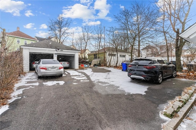 view of front of home with a garage and an outdoor structure