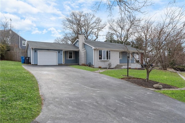 ranch-style home with a front yard and a garage