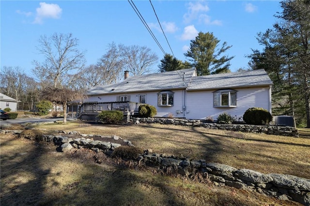 back of property featuring central AC unit, a lawn, and a wooden deck