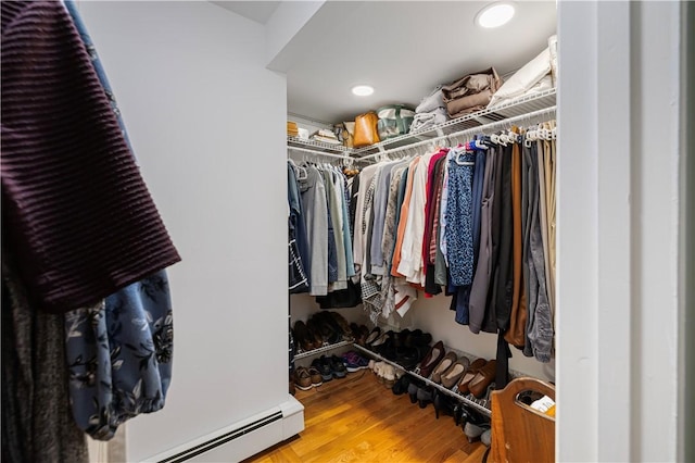 walk in closet with baseboard heating and hardwood / wood-style flooring