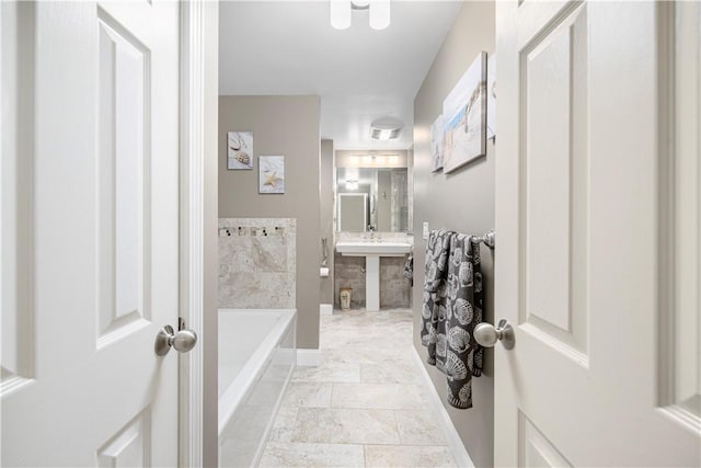 bathroom with tiled bath