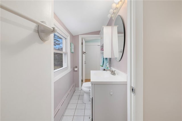 bathroom featuring toilet, vaulted ceiling, tile patterned flooring, baseboard heating, and vanity