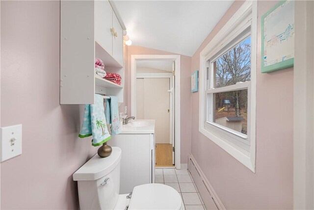 bathroom with lofted ceiling, tile patterned flooring, toilet, and vanity