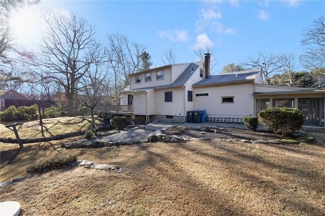 rear view of property with a yard