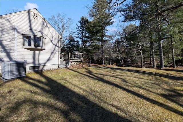 view of yard featuring a deck and central AC unit