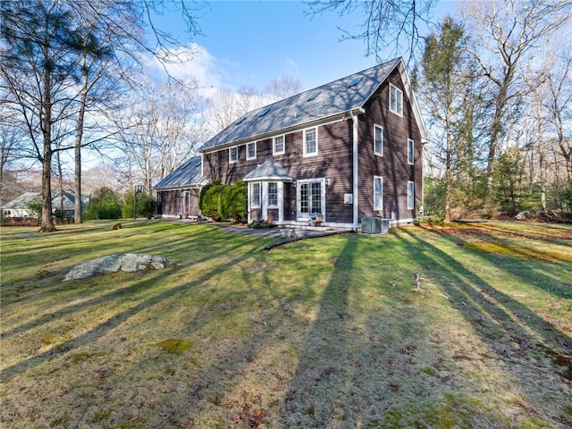 back of house with a patio area, central AC unit, and a lawn