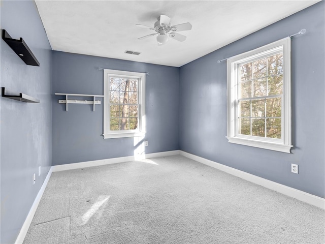 carpeted empty room featuring ceiling fan