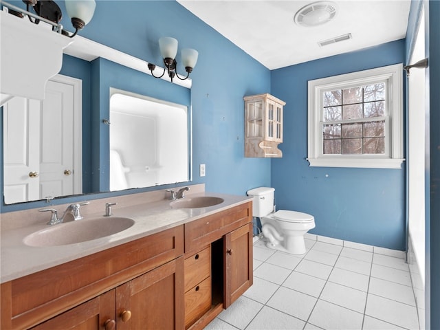 bathroom with vanity, tile patterned flooring, and toilet