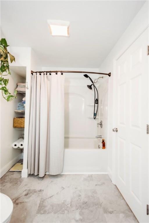 bathroom featuring toilet and shower / bathtub combination with curtain