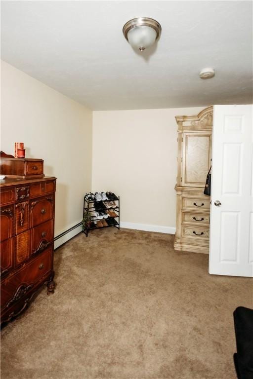 miscellaneous room featuring a baseboard radiator and light carpet