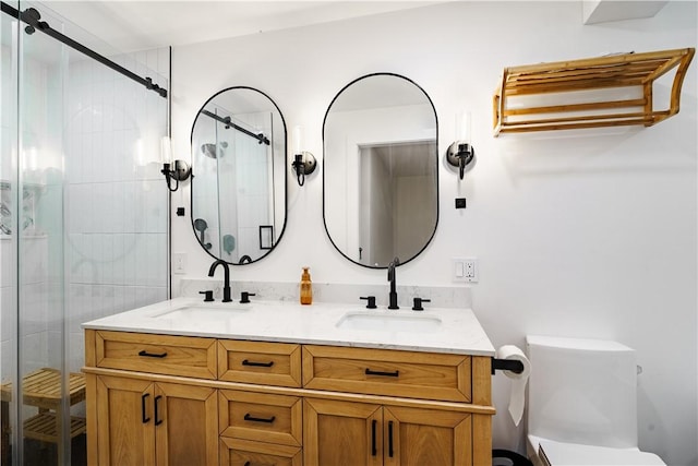 bathroom featuring toilet, a shower with shower door, and vanity