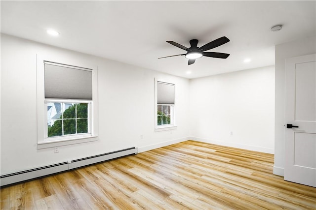 unfurnished room with light wood-type flooring, ceiling fan, and a baseboard radiator