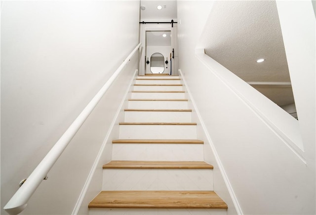 stairway with a textured ceiling