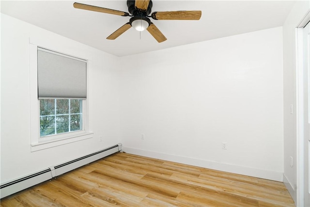 empty room featuring ceiling fan, baseboard heating, and wood-type flooring