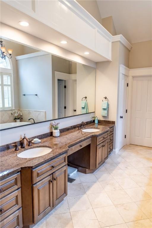 bathroom featuring tile patterned floors, vanity, an inviting chandelier, and vaulted ceiling