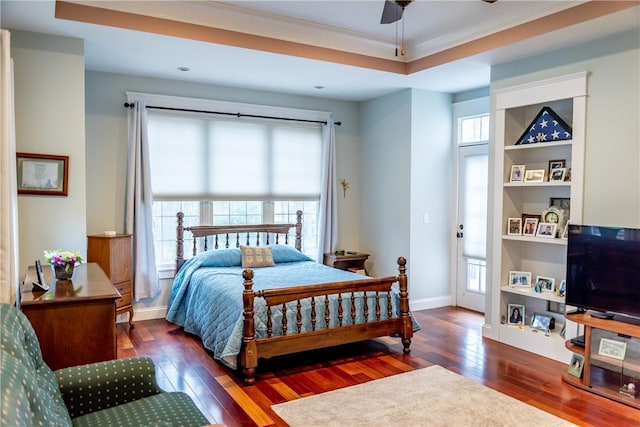 bedroom featuring multiple windows, ceiling fan, and dark wood-type flooring