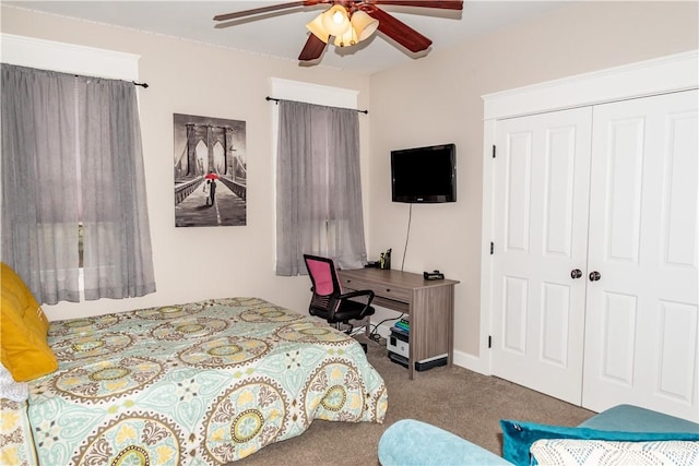 bedroom featuring ceiling fan, a closet, and carpet flooring