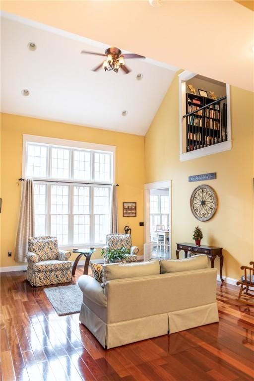 living room featuring hardwood / wood-style floors, high vaulted ceiling, ceiling fan, and plenty of natural light