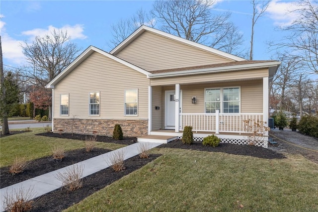 view of front of home with covered porch and a front yard