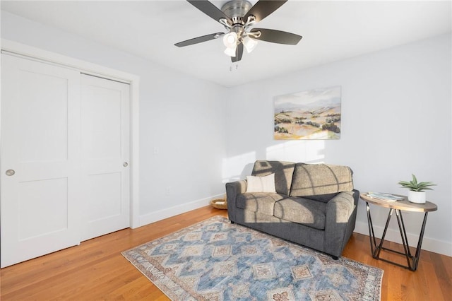 living area with ceiling fan and wood-type flooring