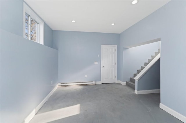 spare room featuring a baseboard radiator and concrete flooring