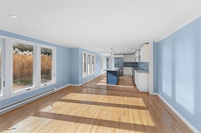 kitchen featuring baseboard heating, a kitchen island, stainless steel refrigerator with ice dispenser, white cabinetry, and decorative light fixtures