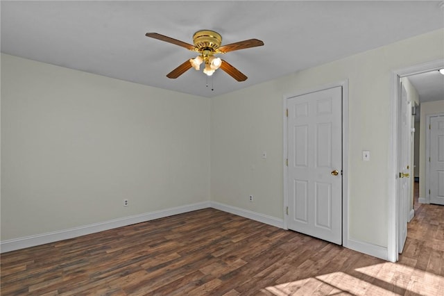 unfurnished room with ceiling fan and dark hardwood / wood-style floors