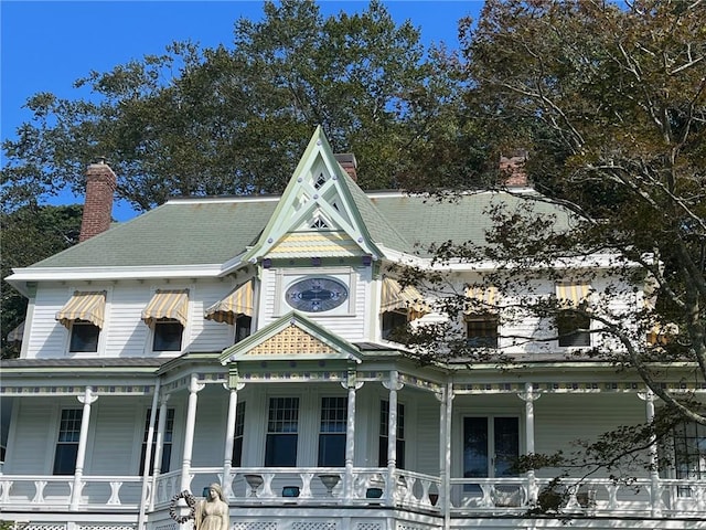 view of front of property with covered porch and a chimney