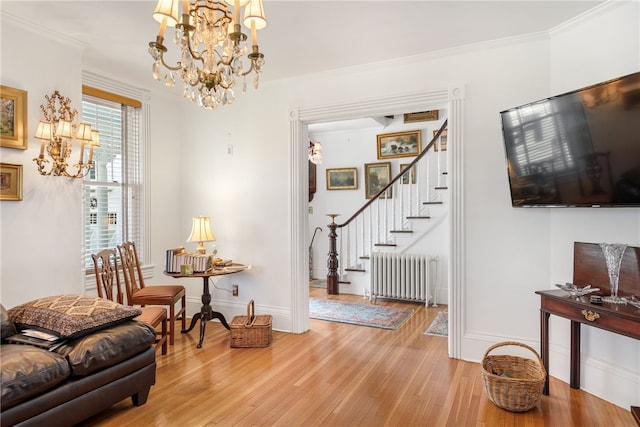 interior space with baseboards, radiator heating unit, stairway, crown molding, and light wood-type flooring