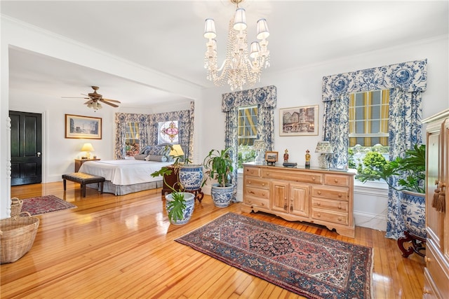 bedroom with crown molding, multiple windows, and hardwood / wood-style floors