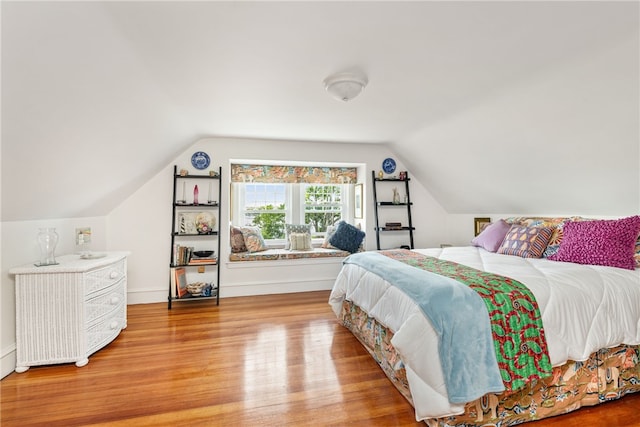 bedroom featuring vaulted ceiling and wood finished floors