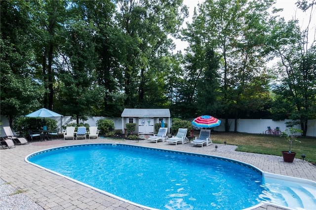 view of swimming pool featuring a patio area and an outdoor structure