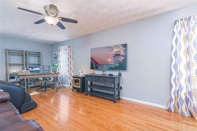 living room with ceiling fan and hardwood / wood-style floors