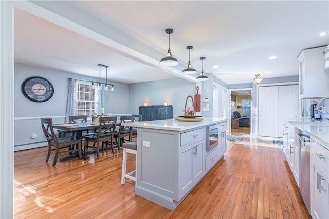 kitchen with pendant lighting, white cabinetry, and a center island