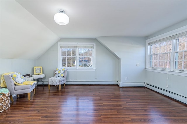 bonus room featuring dark hardwood / wood-style flooring, lofted ceiling, and a baseboard heating unit