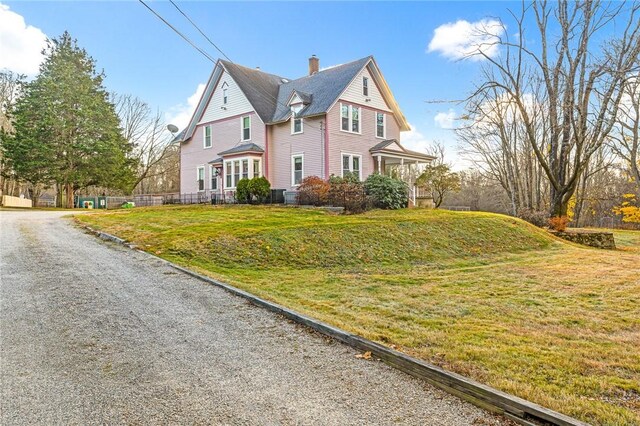 view of property exterior with a yard