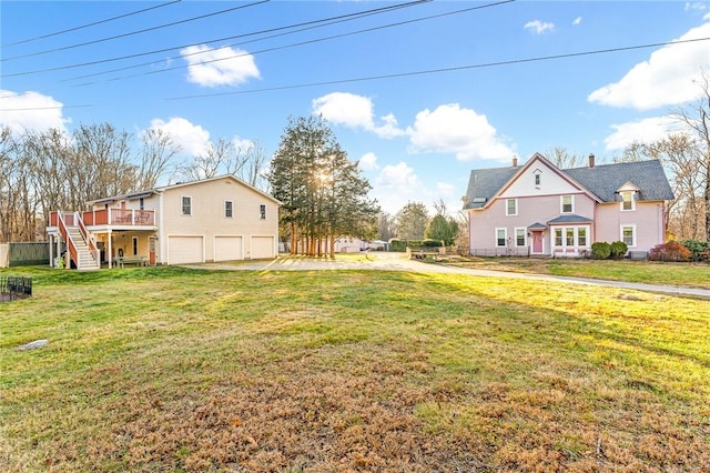 view of yard with a garage and a wooden deck