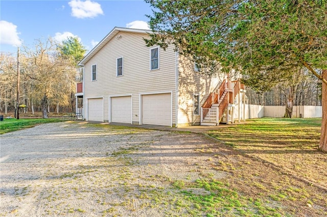 view of home's exterior with a garage and a yard