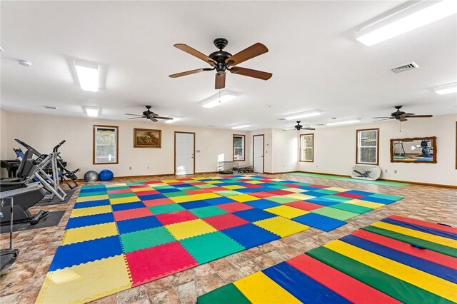 exercise room with ceiling fan