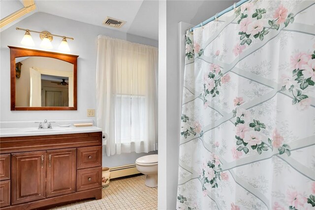 bathroom with toilet, a shower with curtain, a baseboard heating unit, tile patterned floors, and vanity