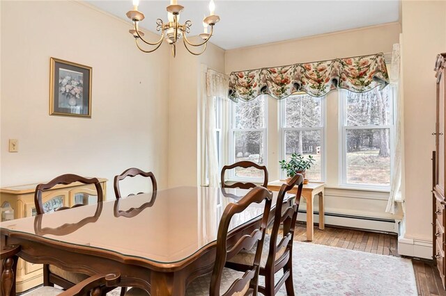 dining room featuring baseboard heating, an inviting chandelier, and hardwood / wood-style flooring