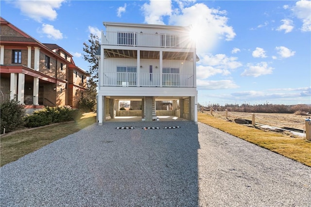 view of front of house with a carport and a balcony